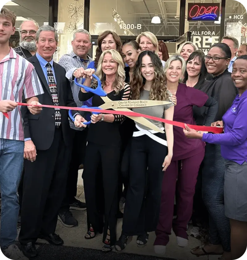 Ribbon-cutting celebration outside a Physicians Weight Loss clinic