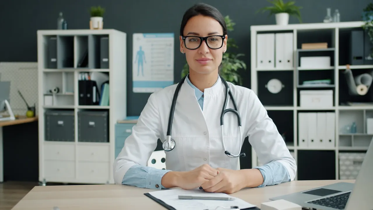 Clinician sitting at a desk in a bright, modern practice office